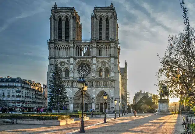 Photo of Notre-Dame facade in the morning in Ile de la Cité to illustrate a walking tour from Notre-Dame to Le Marais in  Paris, France.