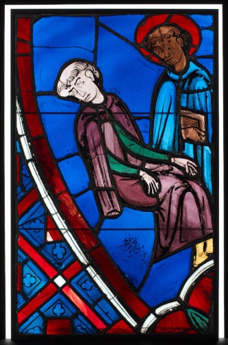 Photo of a Stained glass of former Lady Chapel (distroyed during the French Revolution) representing Saint-Germain the founder of the abbey to illustrate the Saint-Germain-des-Prés Church and Abbey Guided Tour, in Paris, France.