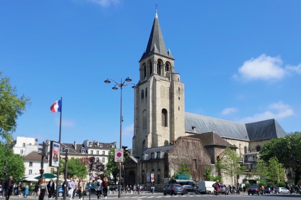 Saint-Germain des Prés church with French flag - broaden-horizons Saint-Germain Walking tour Paris.