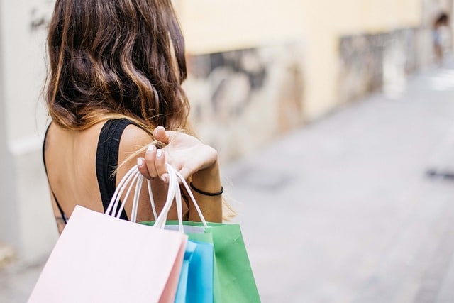 A woman with bags shopping in Paris