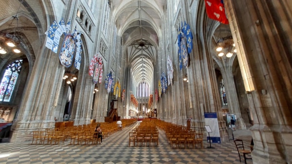 a large cathedral with many chairs and flags