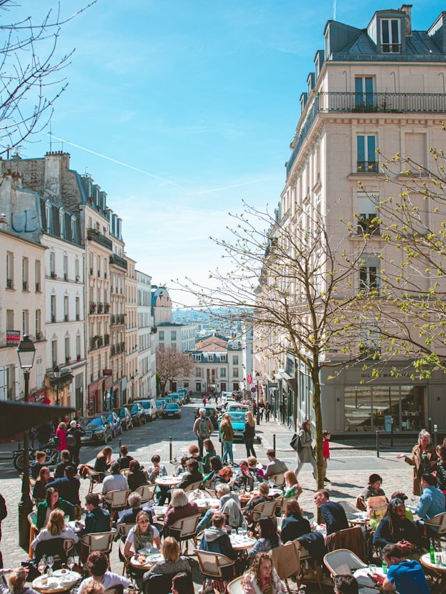 People dining in a quaint Montmartre café with outdoor seating