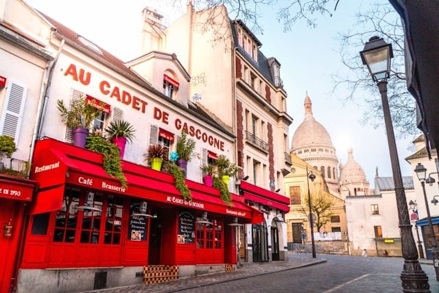 Paris Montmartre street with Sacre Coeur in the background.