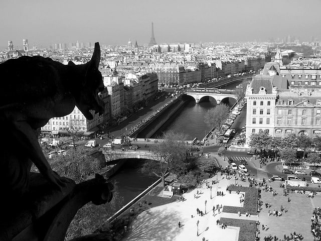 Notre Dame Horned Demon chimera at the North West corner of the South tower. In the background, Saint-Michel, Saint Sulpice, the Invalides, and the Eiffel Tower.