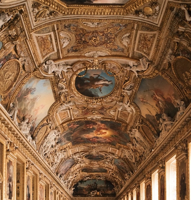 The magnificent painted ceiling of the Apollo Gallery featuring Charles Le Brun's Apollo Slaying the Serpent Python.