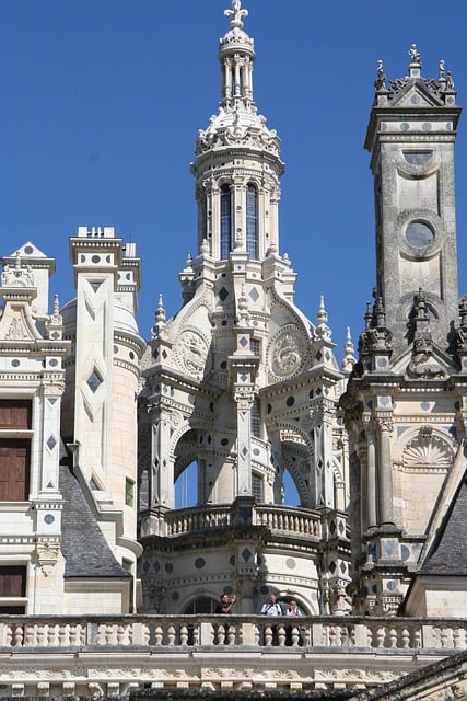 Central lantern tower photographed from the roof terrace surrounded by decorative chimneys.