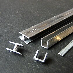 Lead "cames" that hold individual glass pieces together—a technique unchanged since the Middle Ages and still in use in modern stainglass.