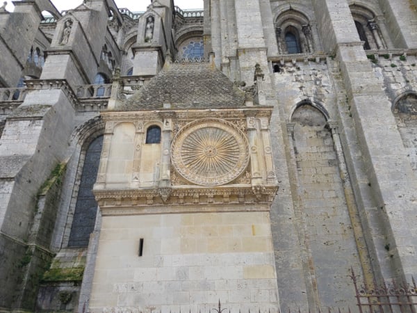 Flying buttresses of Chartres Cathedral — the exterior stone arches that transfer vault thrust from the clerestory walls to freestanding outer piers, making it possible to open the upper walls to vast stained glass windows
